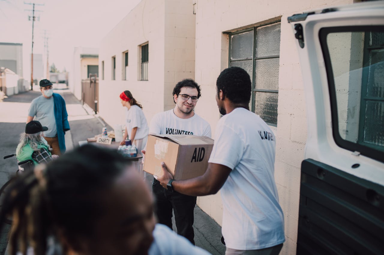services-03 Group of volunteers handing out aid boxes to support community donations.