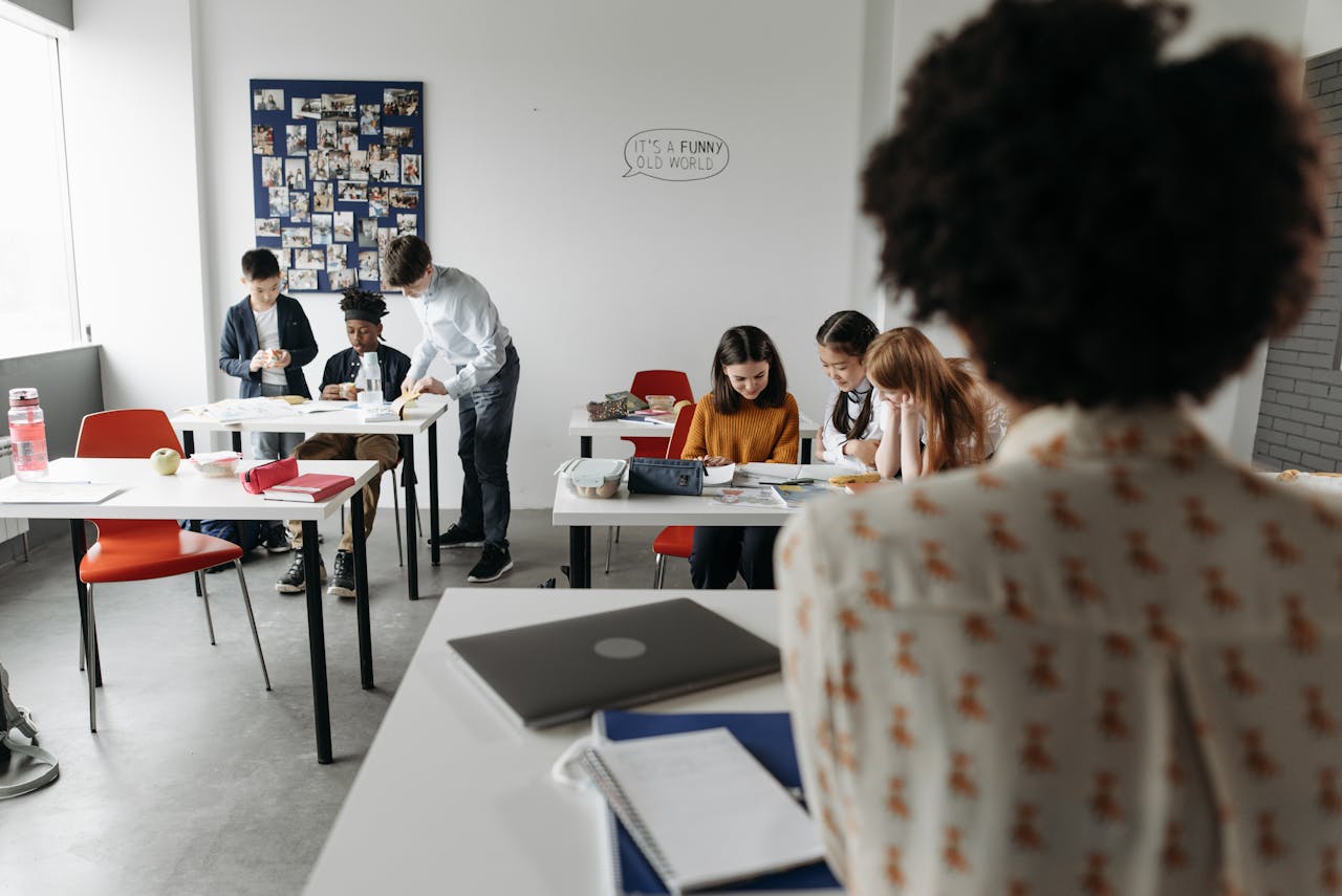 about-01 Students focused in a modern classroom with diverse activities and interactions.